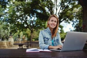 Woman working outdoors on laptop