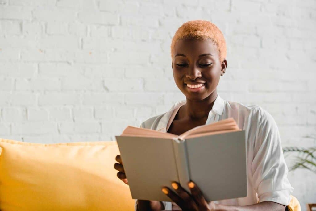 Smiling girl reading a book