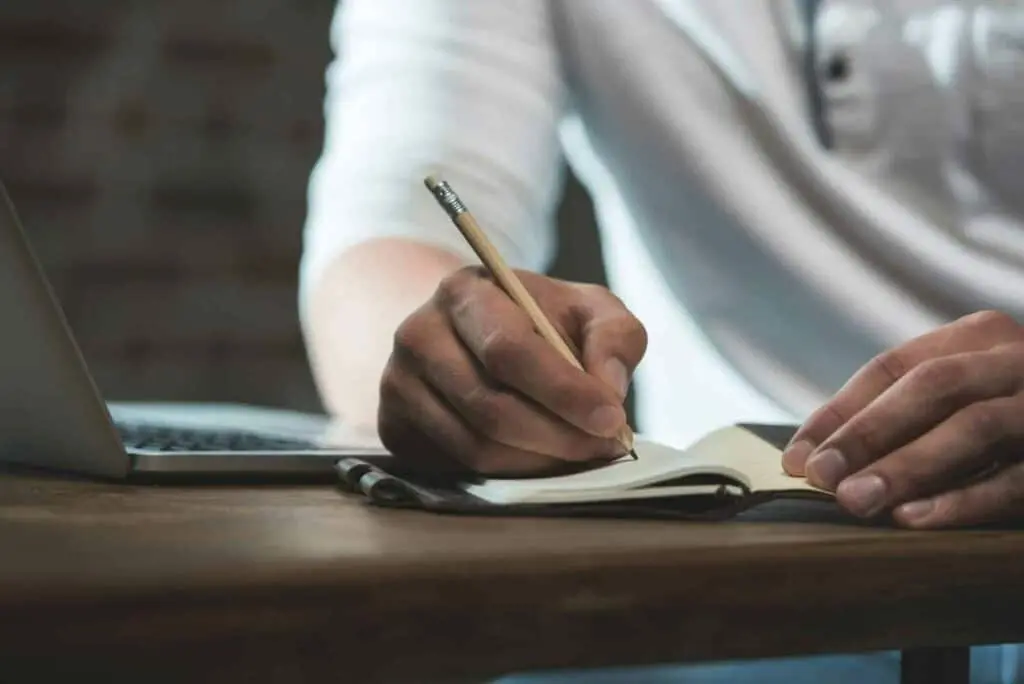 Student writing in notebook