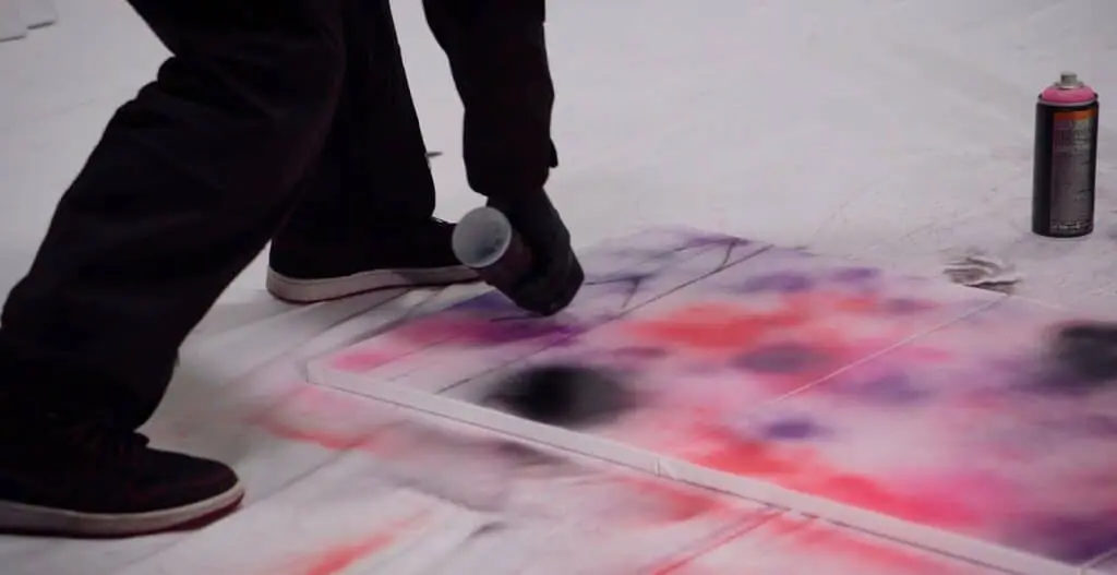 Demonstrating the inverted spray technique using an upside-down spray can