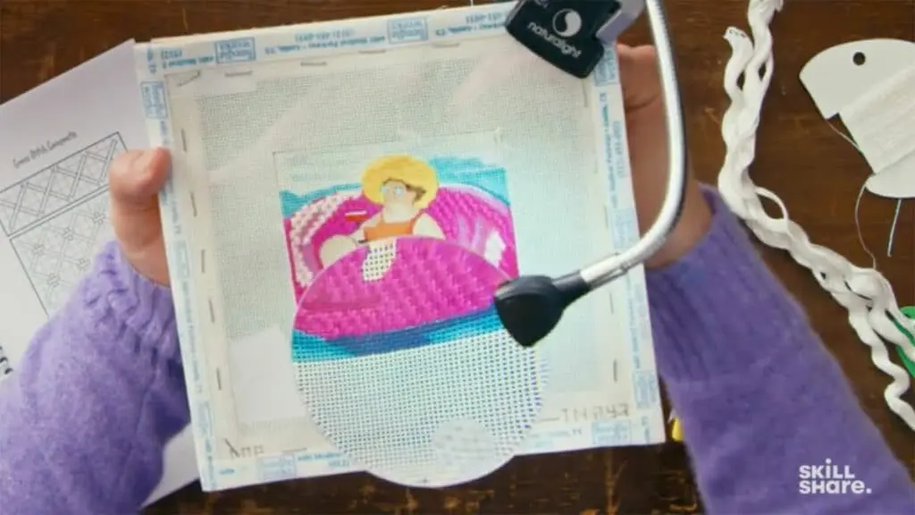 Jonathan Van Ness demonstrating his needlepointing process to learners