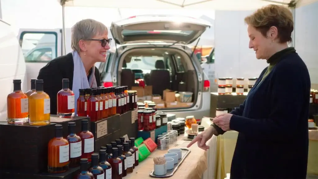 Alice Waters experimenting with fruit and herbal syrups at the farmer's market