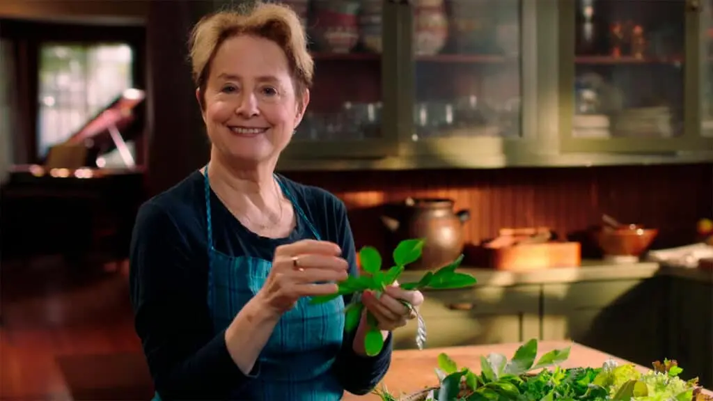 Alice showcasing fresh leaves and herbs