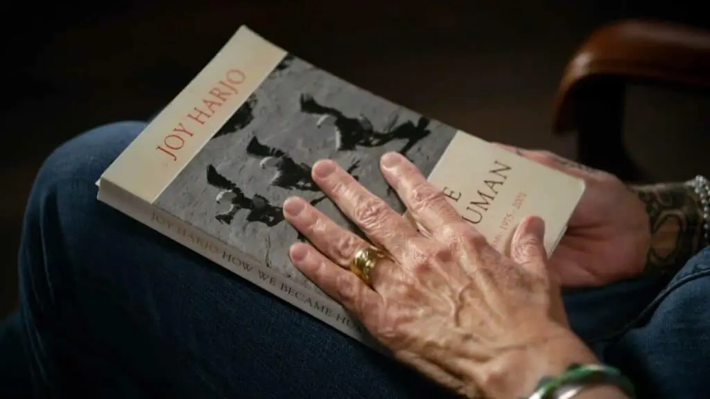 Joy Harjo with her book How We Became Human